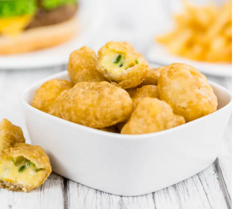chilli cheese nuggets in a white square bowl