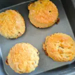 four cooked sultana scones on a air fryer baking tray