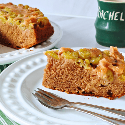 a slice of gooseberry upside down cake on a white plate