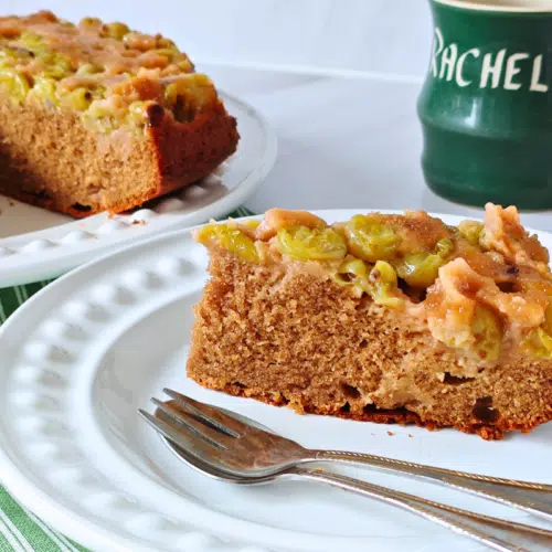a slice of gooseberry upside down cake on a white plate