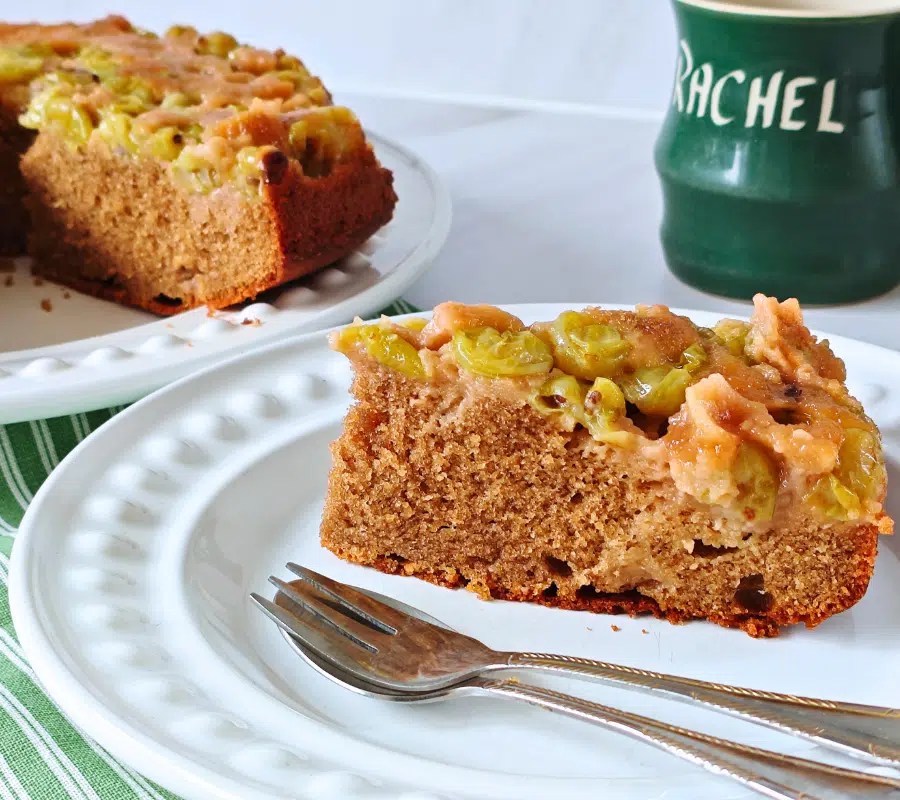 a slice of gooseberry upside down cake on a white plate